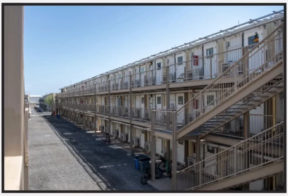 Camp Lemonnier uses stacks and rows of "Containerized Living Units," or CLUs, which the military likens to shipping containers, to house thousands of personnel at the U.S. base in Djibouti. A group of migrants is being held in a converted shipping container, according to court filings.
U.S. Navy photo / Screenshot by NPR