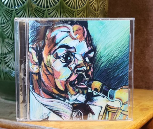 CD cover. A color drawing of a close-up of Albert Aylers face, while playing saxophone.
