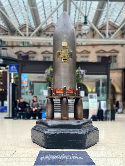 A collection box made from a WWI 15-inch Howitzer shell casing.