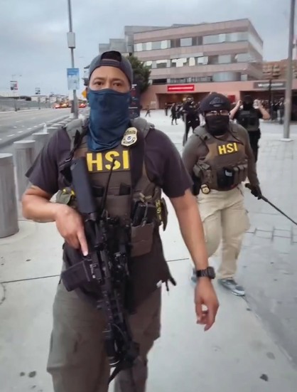 Armed and masked HSI agents chasing after person filming video incredibly aggressively. Agents appear to be people of color, which is even more infuriating,  since they're upholding white supremacy