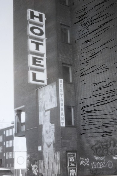 A deliberately scratched picture of a retro looking hotel and restaurant.