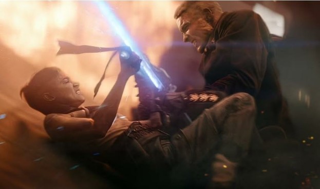 Kora and Noble (TOTAL misnomer) fights with laser swords. He is dressed like a nazi and she is dressed like a warrior in tank top. Behind them are flames.