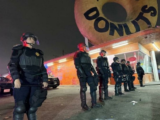 Police in Los Angeles lined up outside of the iconic doughnut shop that is featured in many movies.