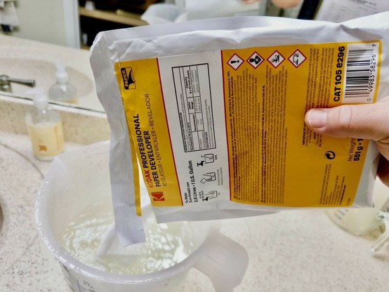 Pouring a package of Kodak paper developer into a container of water. Mmm, such a satisfying whisper.