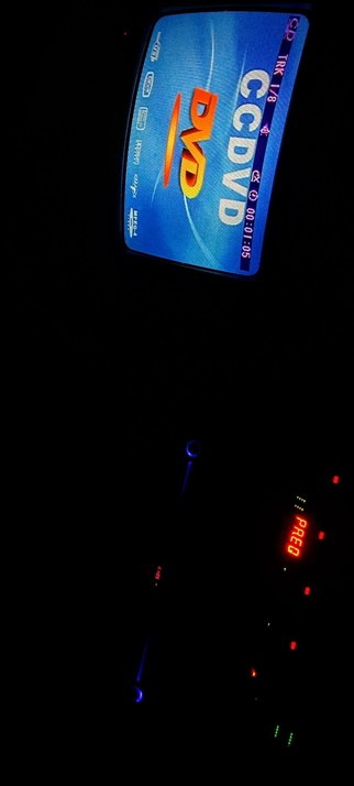 The composition conceived in absolute darkness shows a  dashboard with a DVD player screen and a digital display. The DVD player screen is blue with the text "DVD" in large orange letters and "CCDVD" in white letters. The screen also displays "TRK 1/8" and a time of "00:01:05." The digital display at the bottom shows "PR.EQ" in red, indicating a 19 inch rack mount effect. The dashboard is dimly lit, with some blue and red lights visible, suggesting the CCD also captured other FX equipment like a rack mount mixer and other effects

All is in a dark environment. The overall scene is set inside a Studio, with the focus on the DVD player and digital display.

 Ovis2-8B

🌱 Energy used: 0.167 Wh