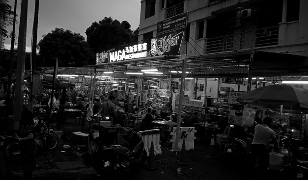 Black and White shot of a hawker center called Maga Restaurant in Penang during dinner time.