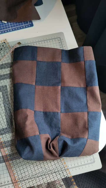 Beginning of a navy blue and brown patchwork bag.