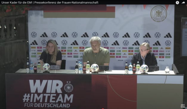 Das Podium mit Nia Künzer im Schatten, Christian Wück halb in der Sonne und Annette Seitz in der Sonne. Die Beleuchtung ist nicht ideal.