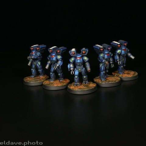 Five Battletech Elementals, painted in the dark blue and green of Clan Diamond Shark standing in a V formation against a dark background.