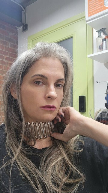 Katherine checks the fit of Xover0's solid sterling silver choker necklace.