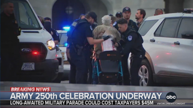 An 87 year old protester is taken from his walker to be handcuffed & arrested.