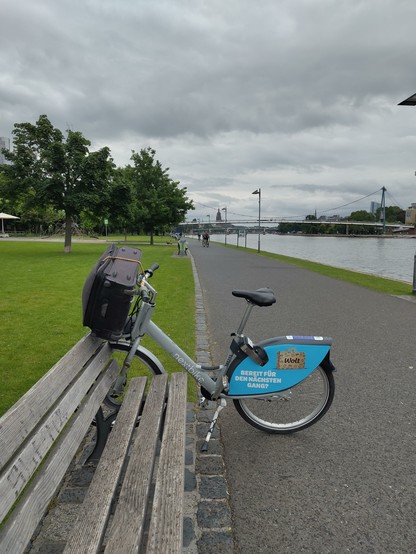 A nextbike shared bike on a promenade across the river