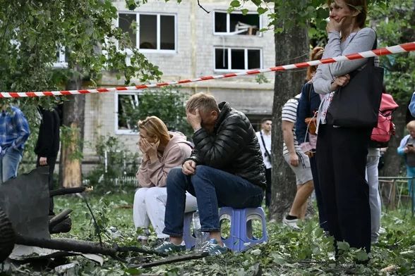 Residents look on as emergency service carry out search and rescue  at a heavily damaged apartment block following Russia's missile and drone strikes on Kyiv, Ukraine, June 17, 2025 (Genya Savilov/AFP/Getty)