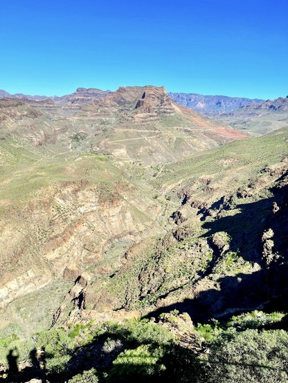 Going from the south of the island up north, there is this local road taking you to this rather spectacular viewpoint: Degollada de las Yeguas. It takes about 10 minutes to get there with the car and then you can embark on different hiking routes in which one can admire such gorgeous views of the mountains in the far back of the snap shot. You can even see two of the landmarks from the island: Risco Blanco & Pozo de las Nieves. 

You can also see some road trails for the more adventurous ones who would want to ride their mountain bikes, or buggies, into the mountains. Intense and lots of great fun, although I'm too old for that now! 

Either way, you can also see me (well, not my body, but you know what I mean, right?) on the snap shot, if you pay close attention, that is, but where?!?! 😉