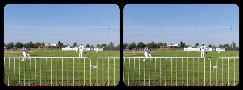 A fence, with baseball players beyond.