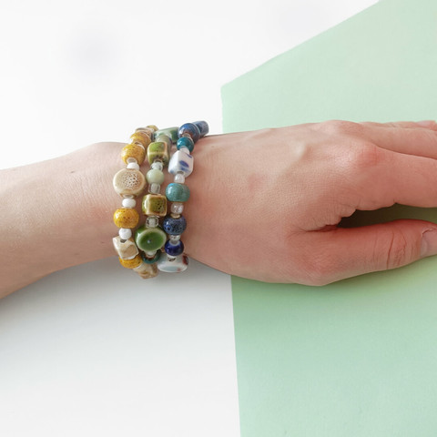 bracelets of ceramic beads in blue, yellow and green