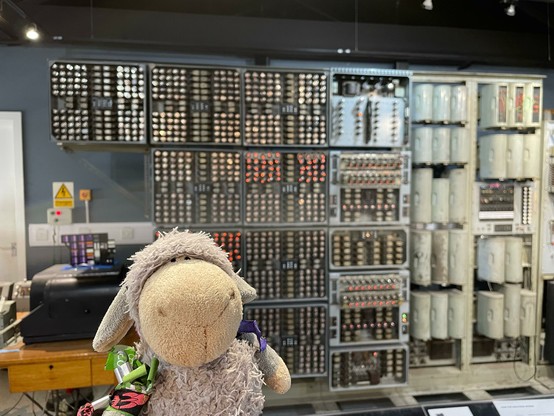 Photo of the grey sheep in front of the WITCH, aka the Harwell Dekatron Computer