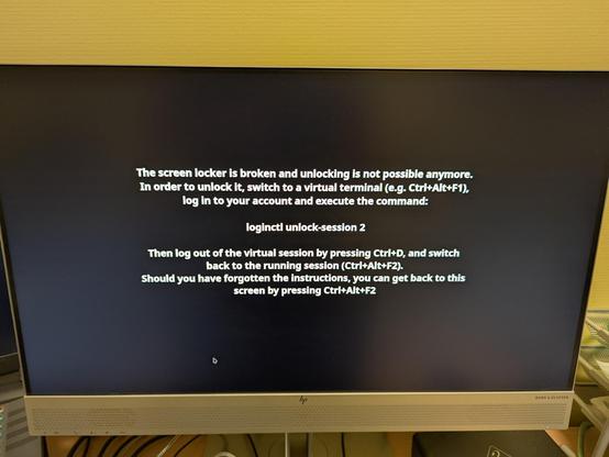 Picture of a computer screen showing the text "The screen locker is broken" and giving instructions on how to unlock the screen on the command line.
