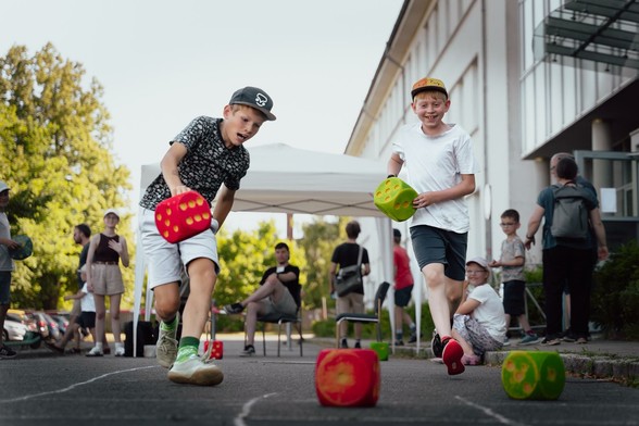 Kinder spielen mit großen Würfeln und rennen um die Wette.

Foto: Silja Klemenz/TU Braunschweig
