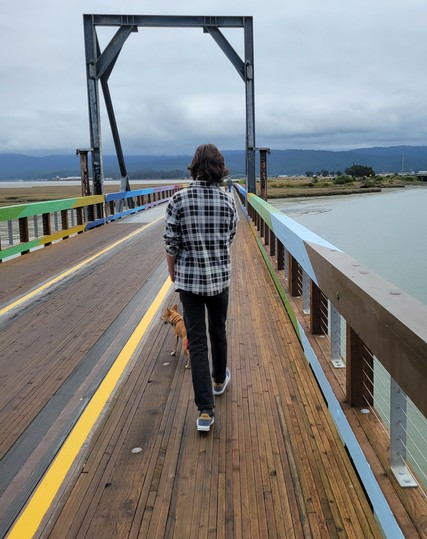 Boy and dog crossing the old railroad bridge. I love the wood slats in this section.