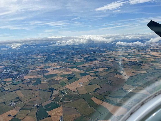 cockpit shot overflying a patchwork of fields