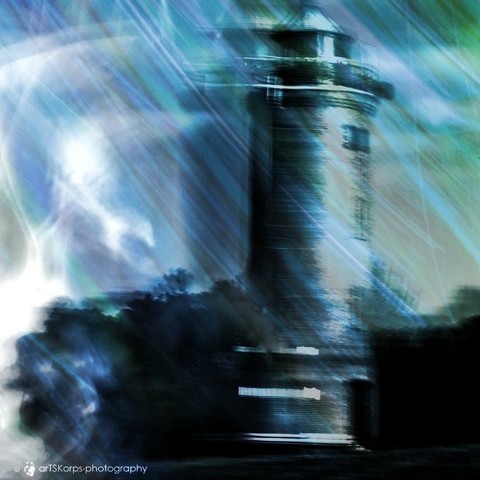 Color photo, multiple exposure, motion-blurred self-portrait, only recognizable as a bright, shadowy silhouette, loke a storm, combined with an ICM photo of a lighthouse and a photo in shades of blue, also ICM. Overall impression: movement, uncertainty, threatening disorientation, cold, and strong wind.