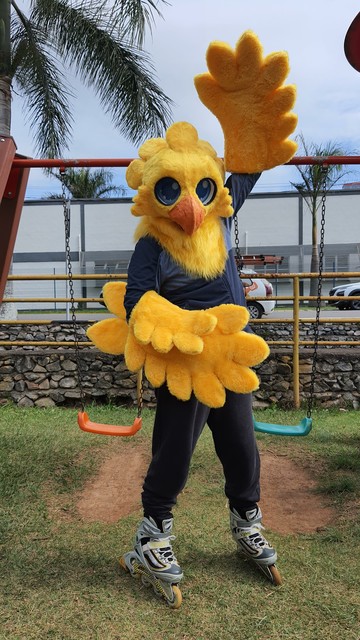 yellow bird fursuit costume with a wing up