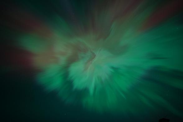 Looking up at the center of the aurora columns where they all line up with our line of sight and looks like a crazy spiral rose pattern of some kind, with red and green mixed in everywhere