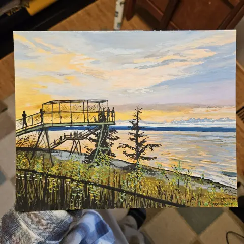 An 8x10 painting looking over carkeek park and the train tracks, over the Puget Sound and towards the Olympic Mountains. There is a layer of clouds low over the peninsula with the white and grey mountain tips peaking out. People stand on the metal pedestrian bridge and stairs, looking at the greys and blues and oranges of the sunset.