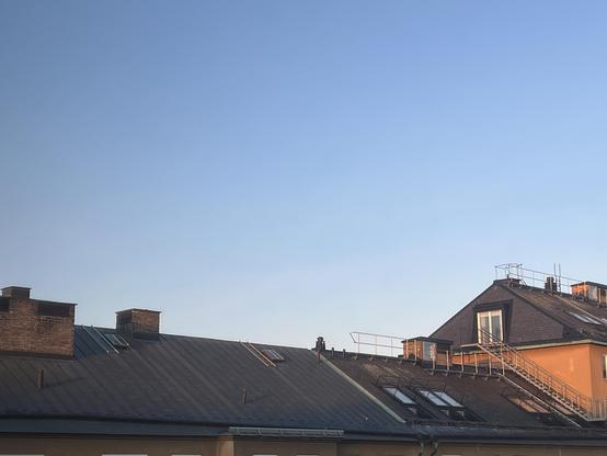 Stockholm skyline March 2026, with a clear pale blue sky and weak early morning sun shining in almost horisontally.