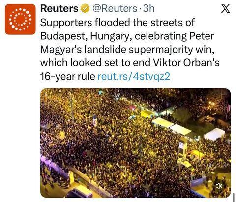 A Reuters tweet reporting that supporters filled the streets of Budapest celebrating Peter Magyar’s landslide supermajority victory, with an aerial nighttime photo of a massive crowd gathered in a city square.