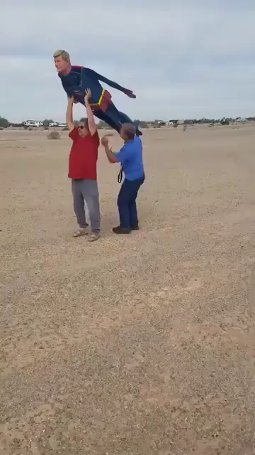 Some people on soft ground playing with a remote controlled......aeroplane? But it is the same size and shape as a superman. It flys like a superman. It looks like superman is flying around. Anyone that sees this is going to think flying people are real. Although the noise does somewhat give it away.