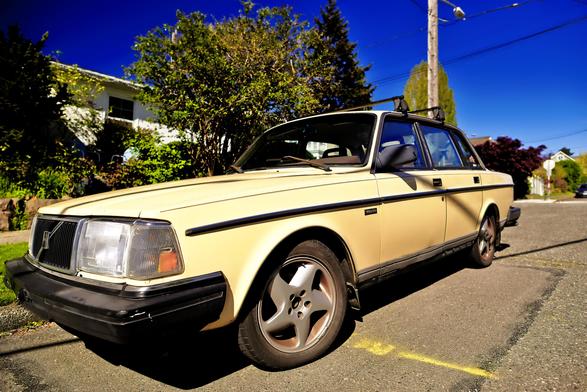 a Volvo parked on the street faces left