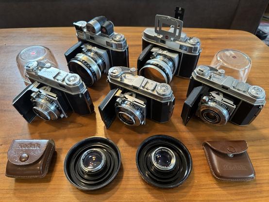A fleet of Kodak Retina 35mm cameras, with various extra lenses and viewfinders