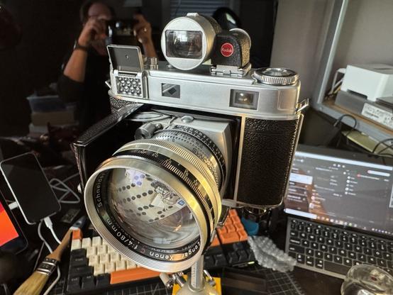 A folding Kodak Retina IIIc with an 85mm lens, viewfinder, and tripod mount.