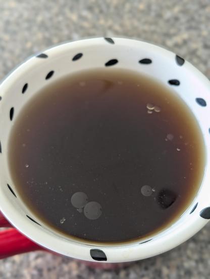 A freshly-brewed cup of Just Coffee Coop's Maya Super Dark coffee in a decorative ceramic mug - flavorful coffee oils are risen to the surface.