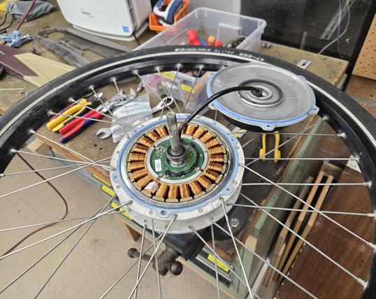 Bike wheel with an integrated direct-drive hub motor. The motor driver electronics are in the center of the hub.