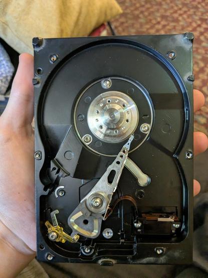An black-colored 3.5" HDD casing with only the spindle motor and head installed