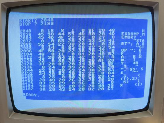close-up photo of a CRT TV screen showing, in typical C64 blue-on-blue, a hexdump of a BASIC program followed by a READY prompt.