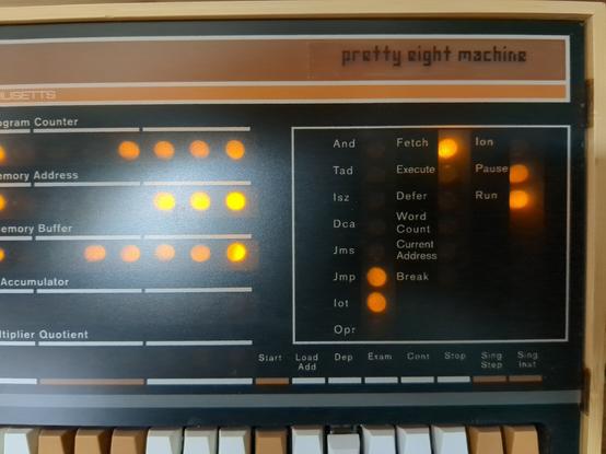 partial image of a PiDP-8 front panel. a transparent sticker in the top right labels it "pretty eight machine" in a pixel font.