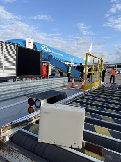 A Toshiba luggable computer from 1993 on a baggage loader at the Schiphol airport. In the background a KLM plane which we just disembarked from.