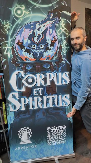 A photo of me showing the roll-up for my game Corpus et Spiritus.