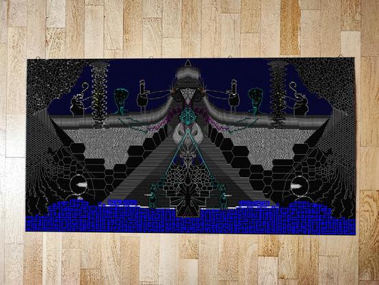A photo of a print with colourful, mirrored ASCII art.
