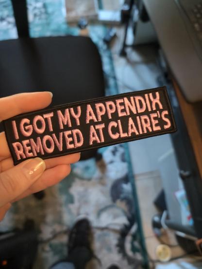A patch that says "I got my appendix removed at Claire's"
