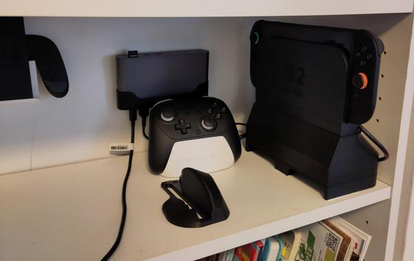 Image of a shelf with a Switch 2 Dock on top of an active cooling base