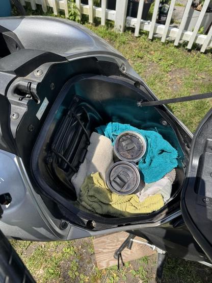 Two coffee tumblers in the frunk of my nc700x with a bunch of kitchen towels shoved in to somewhat keep them from sloshling around