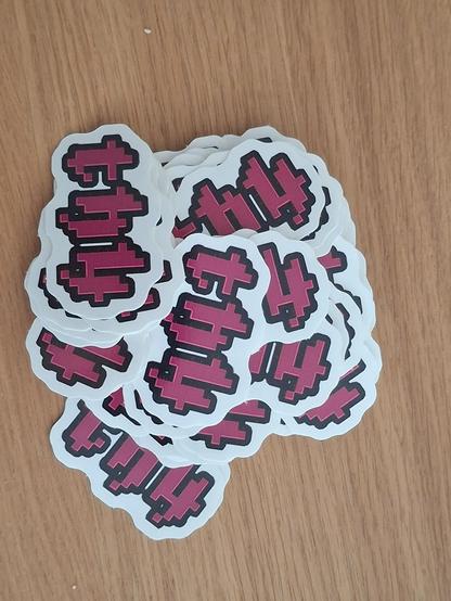 A heap of th4 stickers in the iconic pixel-gothic font and a dark pink color