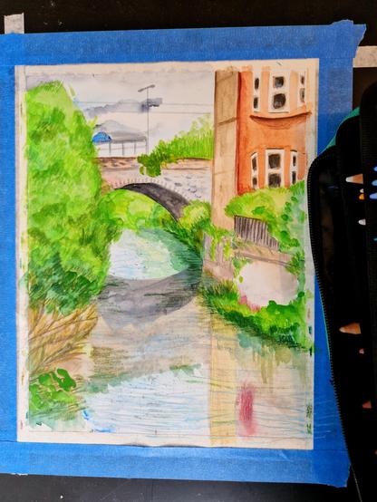 A watercolour and coloured pencil drawing of an urban nature scene. A river surrounded by bushes flows past a tenement building. In the background, a bridge goes over the river. On the bridge a train shelter is visible.