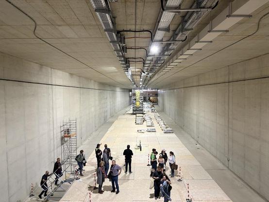 Der geräumige Rohbau der Haltestelle Horner Geest mit Mittelbahnsteig. Es sind noch keine Gleise verlegt, an der Decke sind zahlreiche Kabelkanäle montiert.