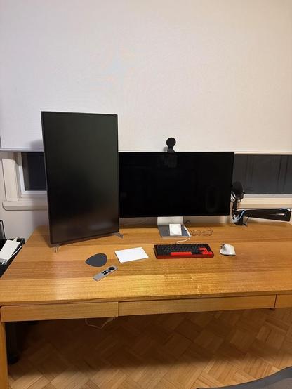 Wooden desk with two monitors. Left in portrait, right in landscape.